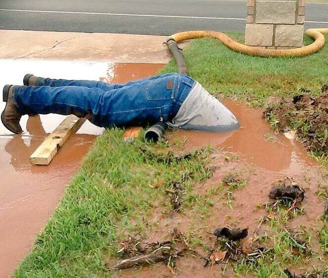 This Photo Of A Dedicated Plumber Submerged In Muddy Water Went Viral