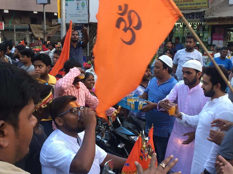 Muslim brothers hand out drinks to Hindu procession